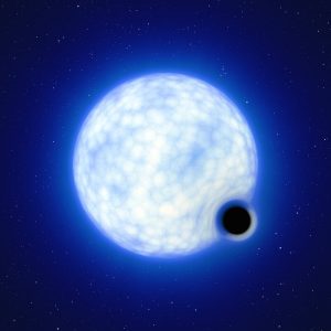 This artist’s impression shows what the binary system VFTS 243 might look like if we were observing it up close. The system, which is located in the Tarantula Nebula in the Large Magellanic Cloud, is composed of a hot, blue star with 25 times the Sun’s mass and a black hole, which is at least nine times the mass of the Sun. The sizes of the two binary components are not to scale: in reality, the blue star is about 200 000 times larger than the black hole.  Note that the 'lensing' effect around the black hole is shown for illustration purposes only, to make this dark object more noticeable in the image. The inclination of the system means that, when looking at it from Earth, we cannot observe the black hole eclipsing the star. Credit: ESO/L. Calçada.