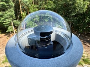 The photo above and the cover photo show the SN20 bolide camera. The fisheye lens (covering 180×160 degrees of sky) is visible under the transparent dome, along with the camera below (blue). Photo by Szymon Kozłowski