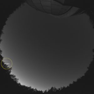 A fireball (circled) recorded by the SN20 fireball station (OAUW Ostrowik near Warsaw). The telescope dome can be seen at the top. Source: Astronomical Observatory UW